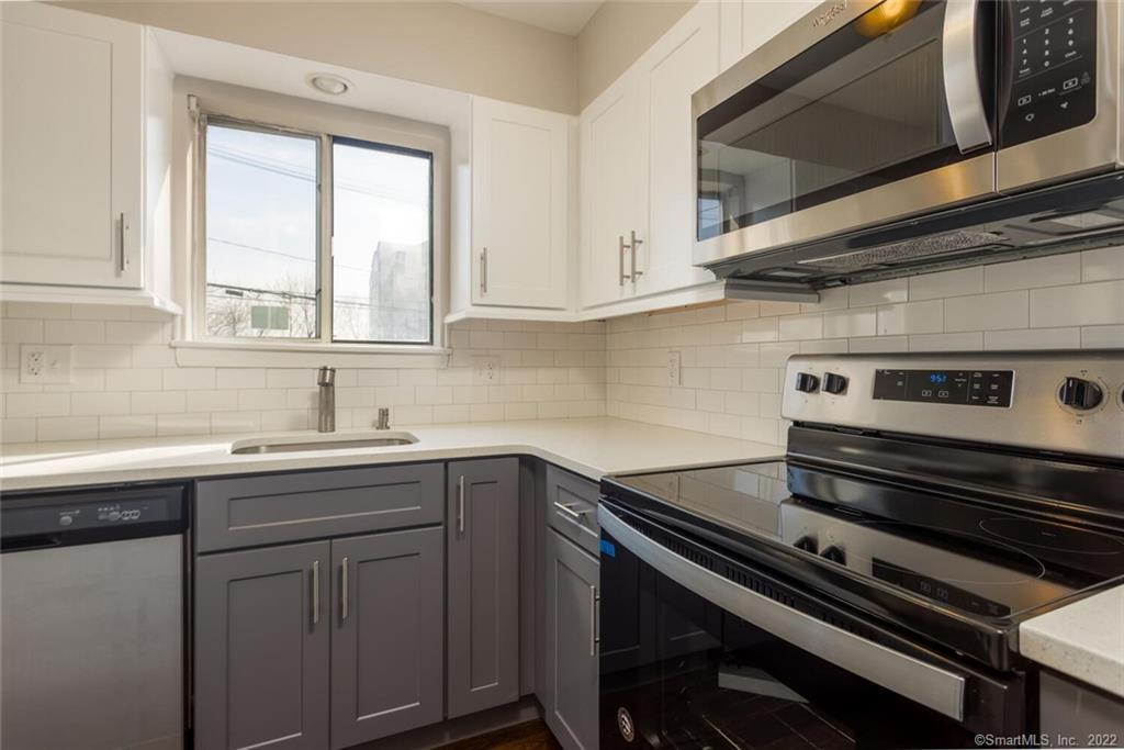 Brand new kitchen top to bottom with new custom cabinets, quartz countertops, stainless steel appliances and hardwood floors and 2 windows for tons of natural light.