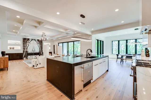 a large kitchen with stainless steel appliances granite countertop a stove a sink and a refrigerator