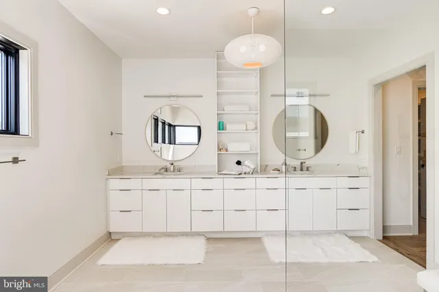 a bathroom with a toilet a sink a mirror and vanity