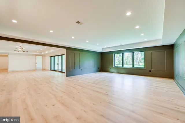 a kitchen with kitchen island a counter top a stove and a sink