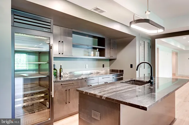 a view of an empty room with wooden floor and closet