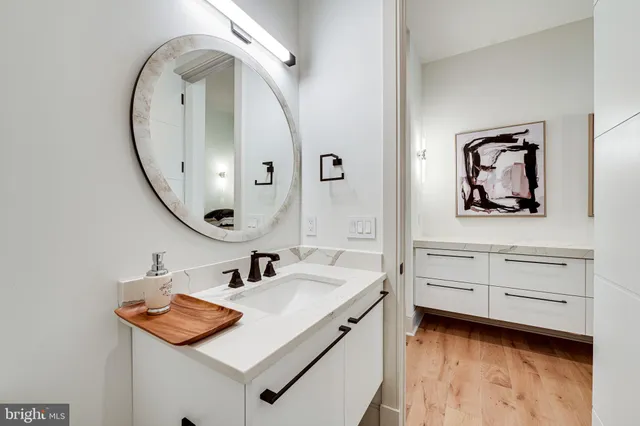 a view of a room with wooden floor ceiling fan and windows