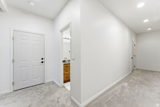 1712 Somerset Ridge Drive Draper, UT 84020 - Photo 54 of 76 Hallway with light gray carpeting, white baseboards, and bright white walls