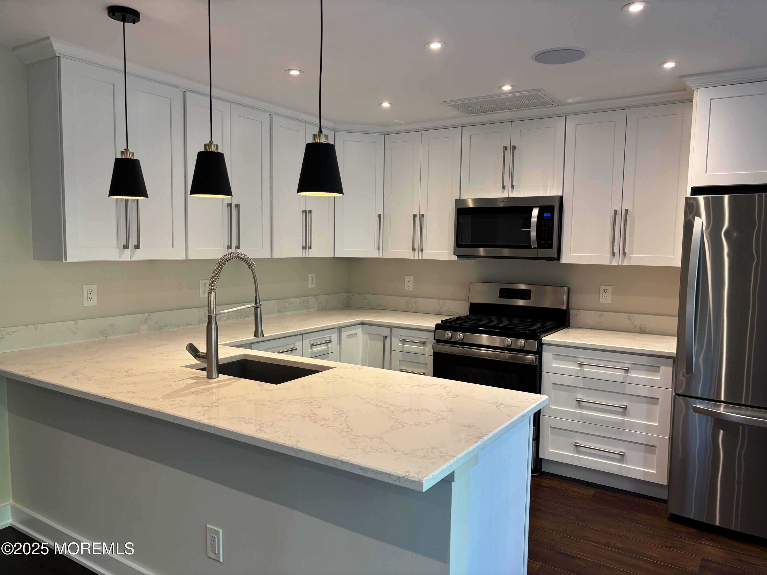 276 Sugar Maple Court Howell, NJ 07731 - Photo 11 of 34 a kitchen with kitchen island a sink stainless steel appliances and cabinets