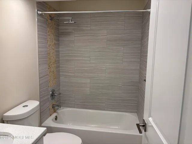 a bathroom with a shower and a white toilet