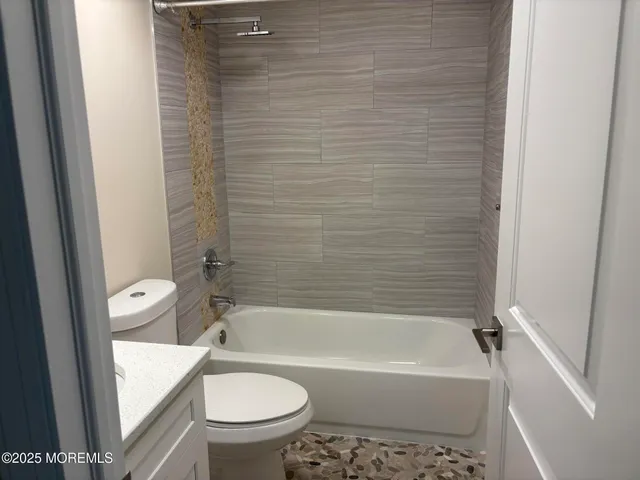 a bathroom with a toilet and a bathtub