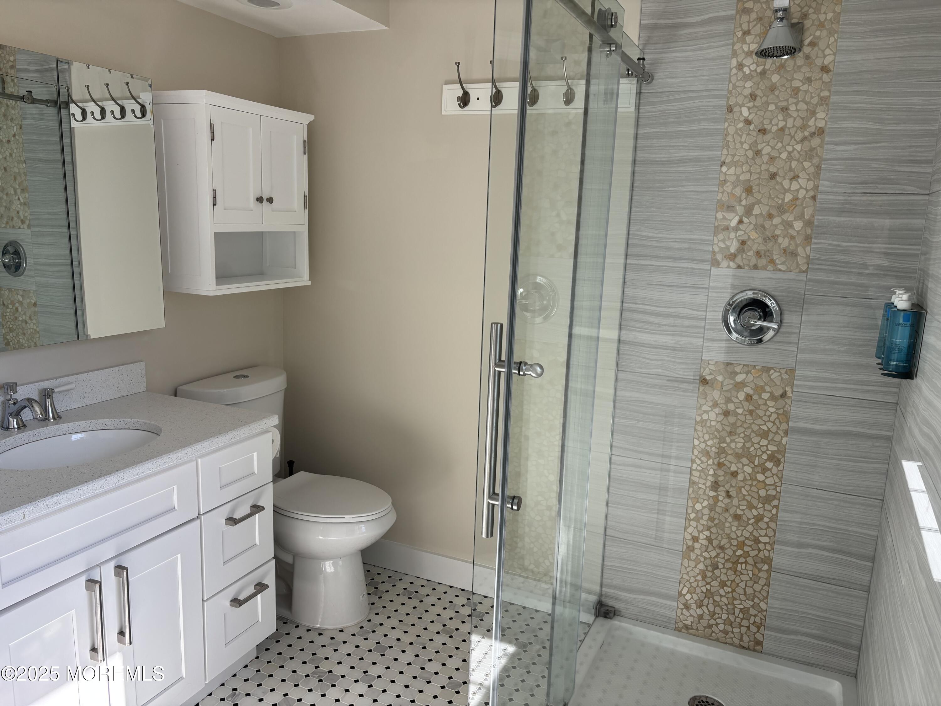 276 Sugar Maple Court Howell, NJ 07731 - Photo 24 of 34 a bathroom with a granite countertop sink a toilet and shower