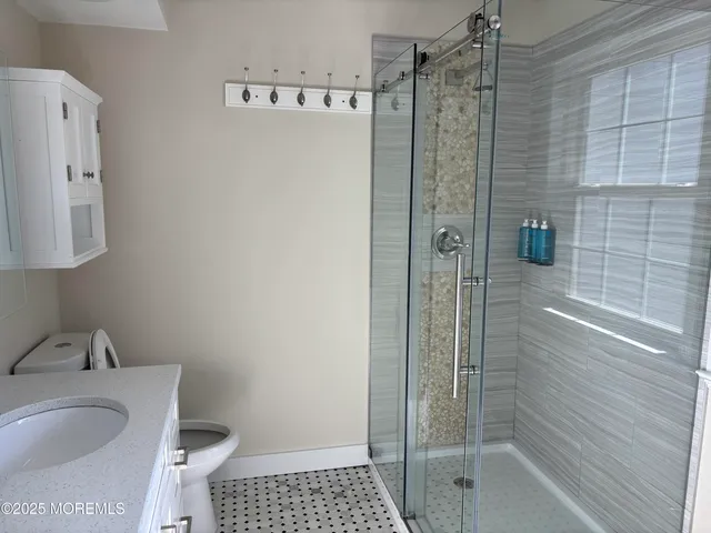 a bathroom with a shower and a sink