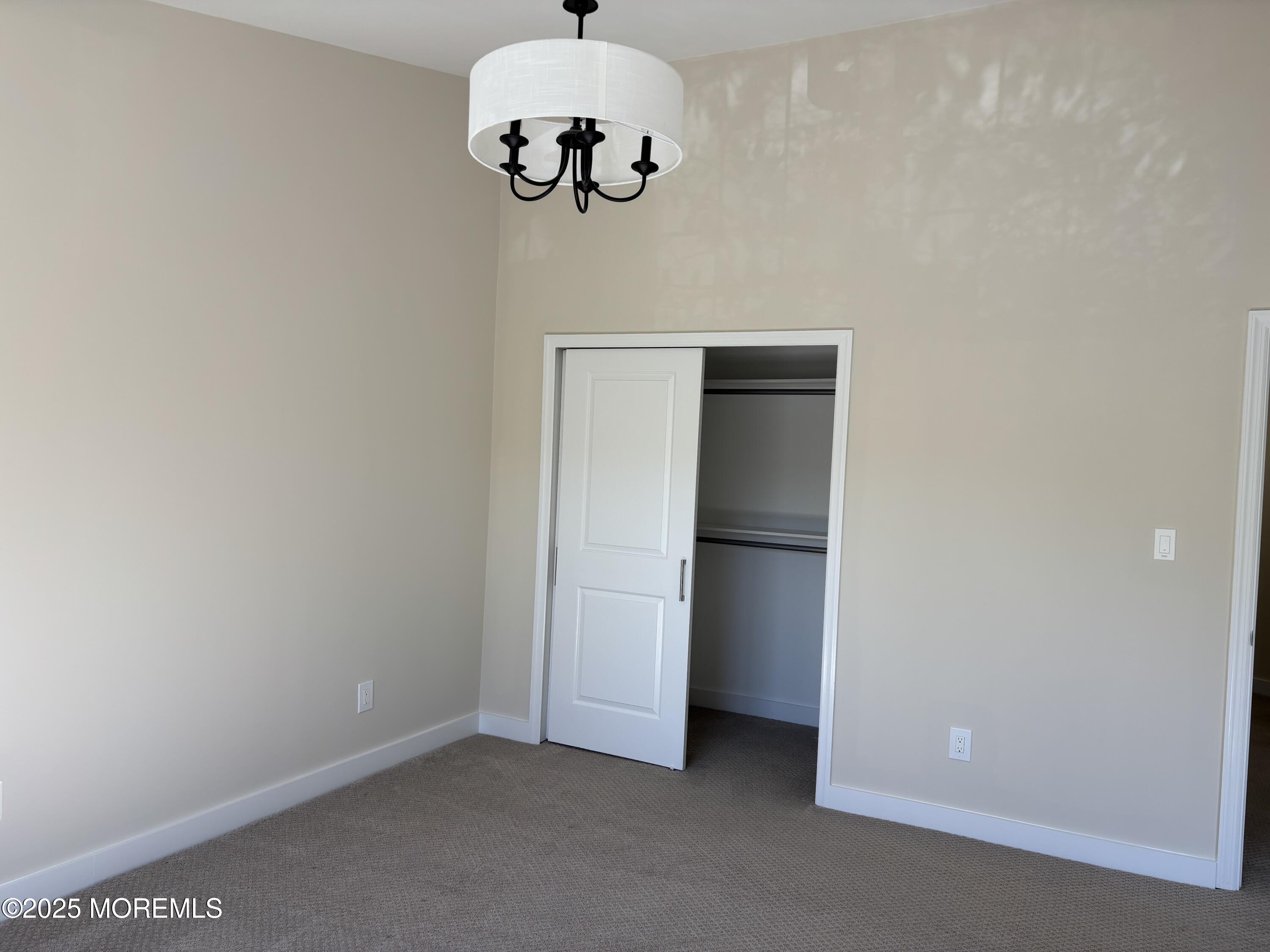 276 Sugar Maple Court Howell, NJ 07731 - Photo 28 of 34 an empty room with a chandelier fan