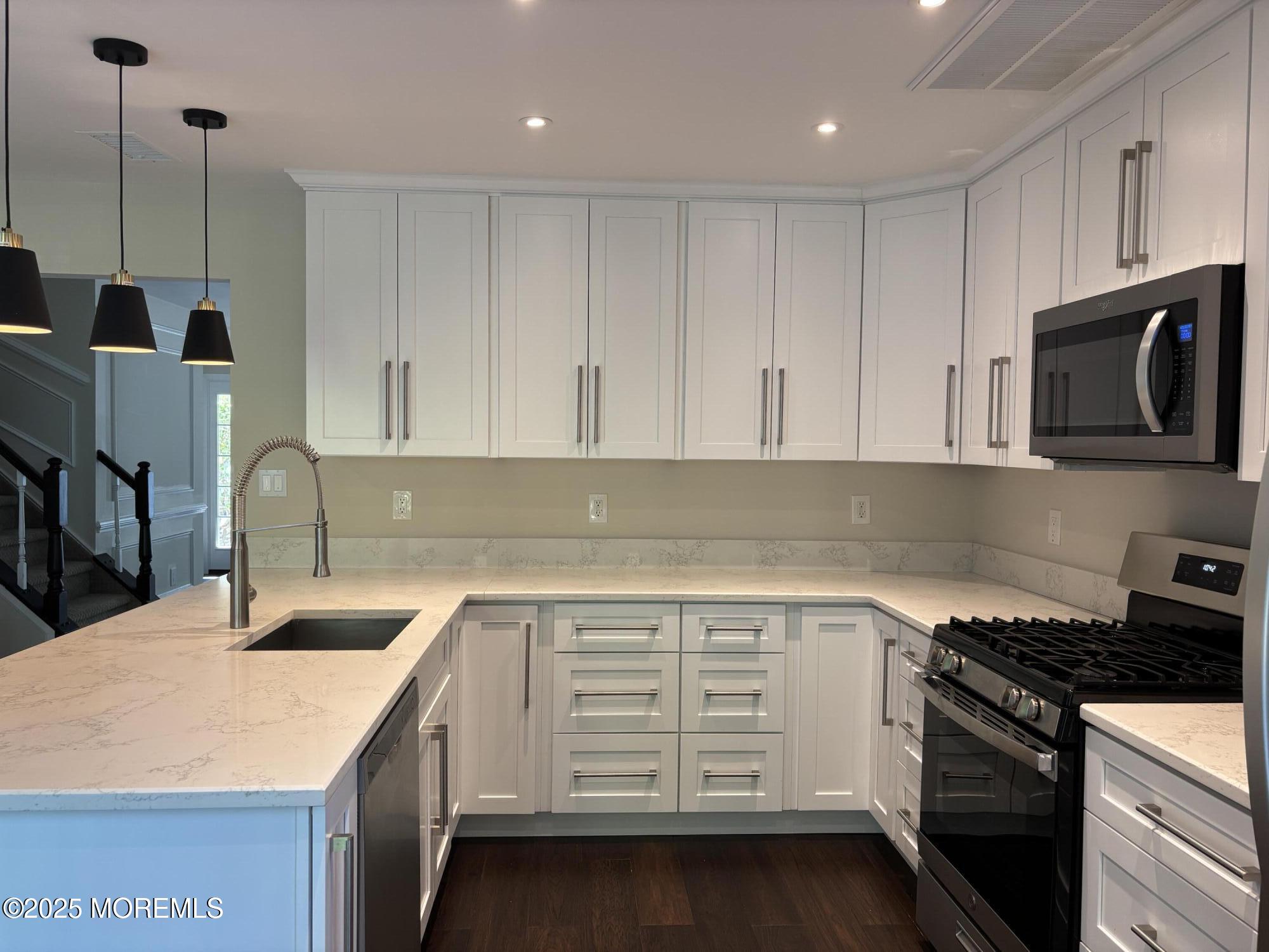 276 Sugar Maple Court Howell, NJ 07731 - Photo 9 of 34 a kitchen with a sink stove and cabinets