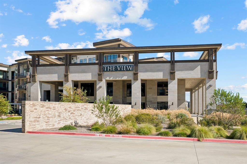 a front view of a building with a garden