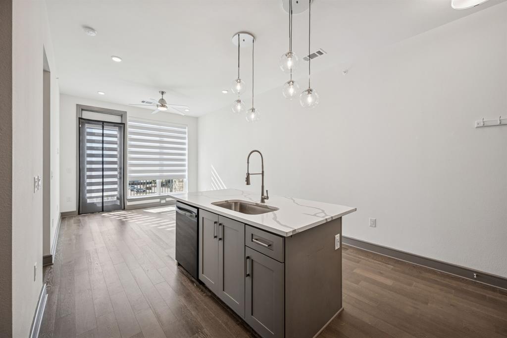 2700 Old Denton Road, Unit 4451 Carrollton, TX 75007 - Photo 11 of 38 a kitchen with a sink a counter space and wooden floor