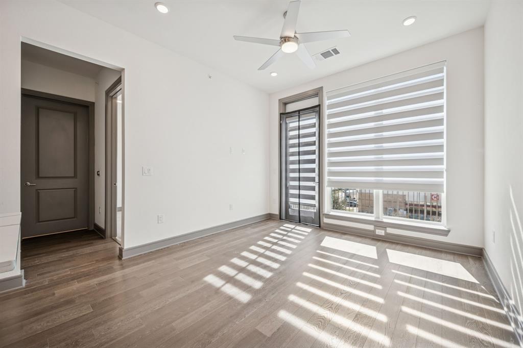 2700 Old Denton Road, Unit 4451 Carrollton, TX 75007 - Photo 14 of 38 a view of an empty room with a window and wooden floor
