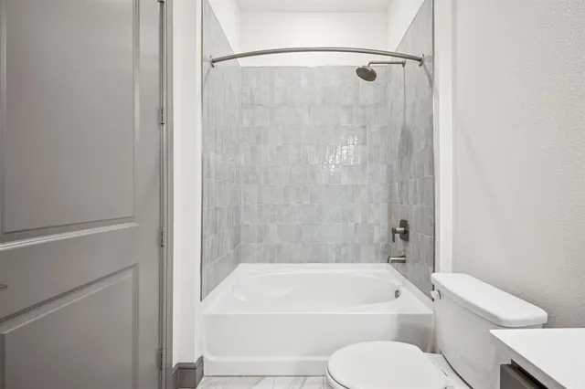 a bathroom with a sink double vanity granite tub shower and a mirror