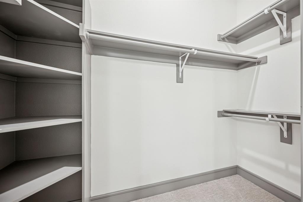 2700 Old Denton Road, Unit 4451 Carrollton, TX 75007 - Photo 22 of 38 a view of a room with racks on the wall