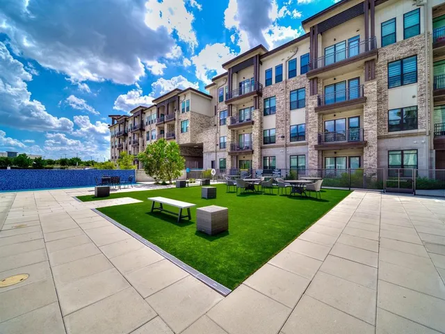 a view of a building and a yard in the back