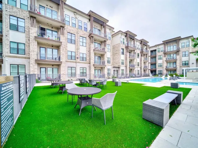 a view of a patio with a table and chairs
