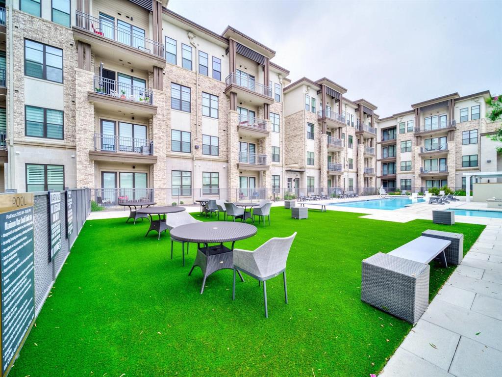 2700 Old Denton Road, Unit 4451 Carrollton, TX 75007 - Photo 37 of 38 a view of a building and a yard in the back