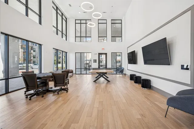 a living room with furniture flat screen tv and wooden floor