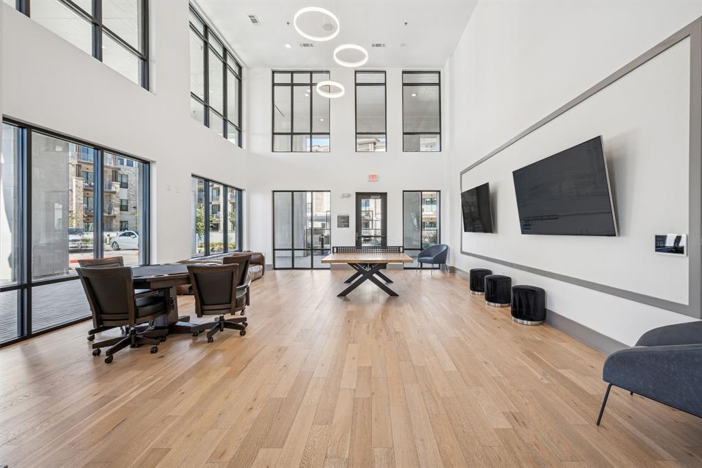 2700 Old Denton Road, Unit 4451 Carrollton, TX 75007 - Photo 4 of 38 a living room with furniture flat screen tv and wooden floor