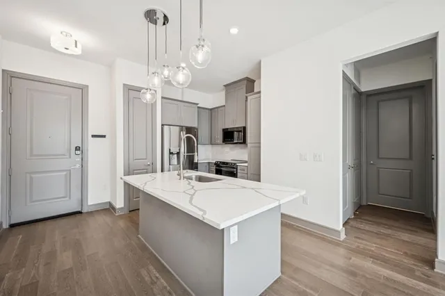 a large kitchen with a large counter top appliances and cabinets