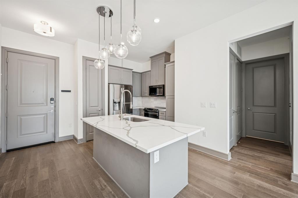 2700 Old Denton Road, Unit 4451 Carrollton, TX 75007 - Photo 8 of 38 a large kitchen with a large counter top appliances and cabinets