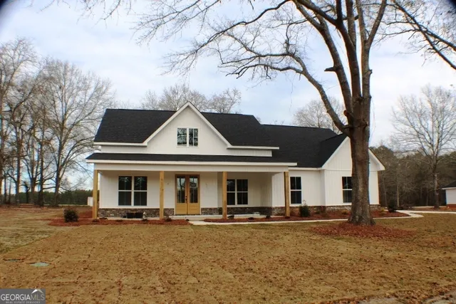 a front view of a house with yard patio and fire pit