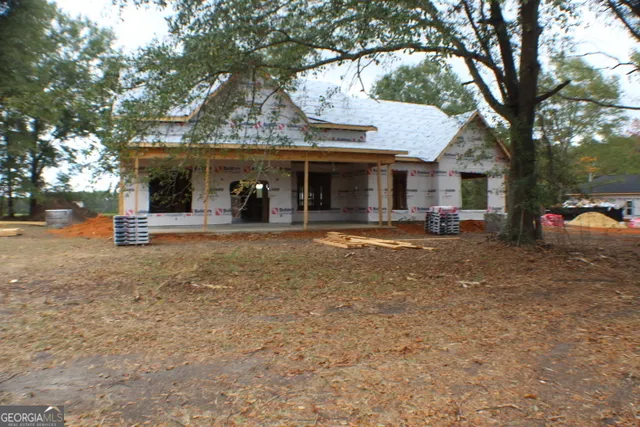 a view of a house with a backyard porch and sitting area