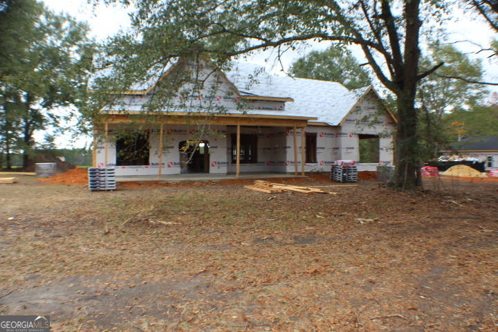 a view of a house with a backyard porch and sitting area