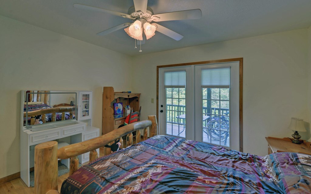 56 Waxwing Trail Murphy, NC 28906 - Photo 17 of 49 a bedroom with a bed and a flat tv screen on dresser