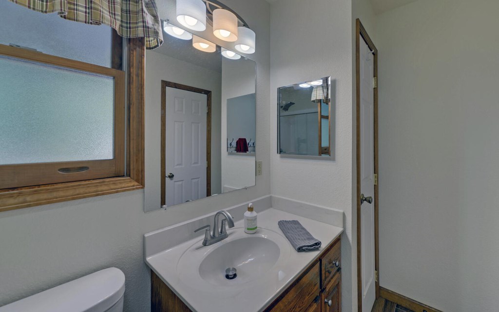 56 Waxwing Trail Murphy, NC 28906 - Photo 18 of 49 a bathroom with a toilet a sink and mirror