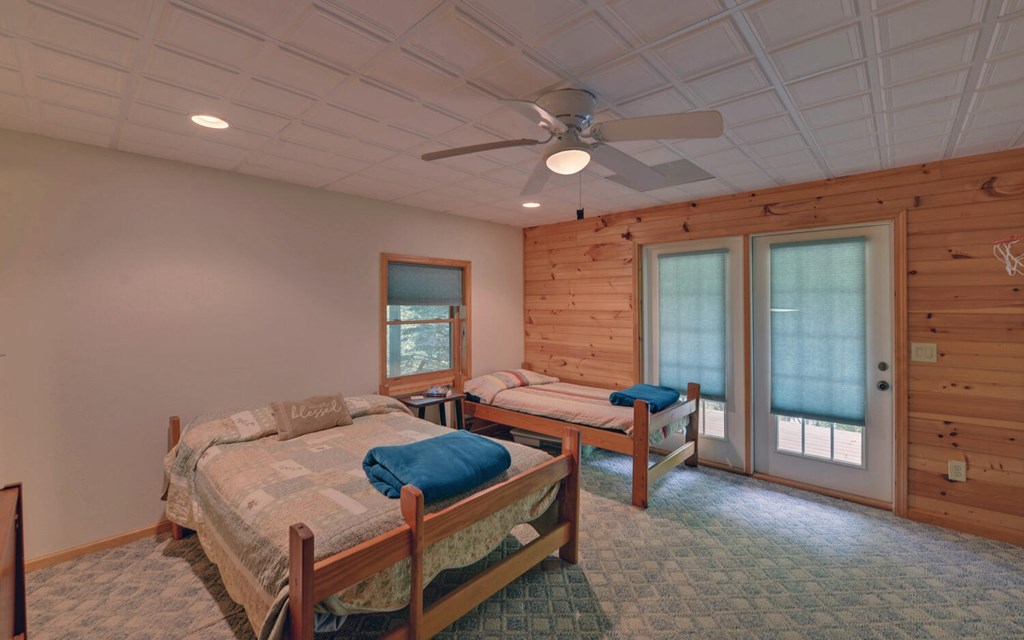 56 Waxwing Trail Murphy, NC 28906 - Photo 30 of 49 a bedroom with a bed and a chandelier