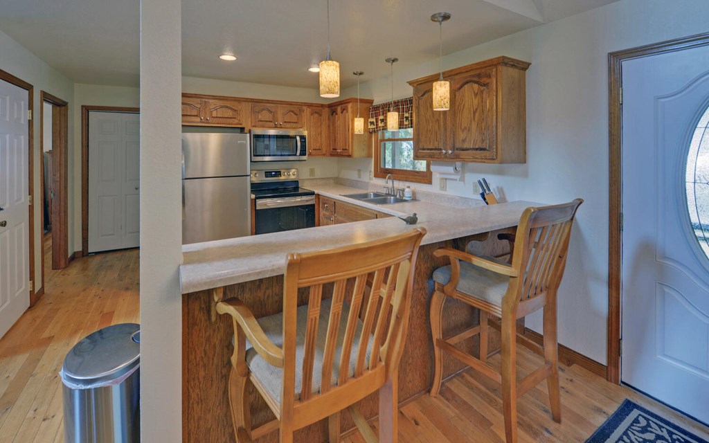 56 Waxwing Trail Murphy, NC 28906 - Photo 7 of 49 a kitchen with stainless steel appliances kitchen island granite countertop a refrigerator a stove a sink and dishwasher
