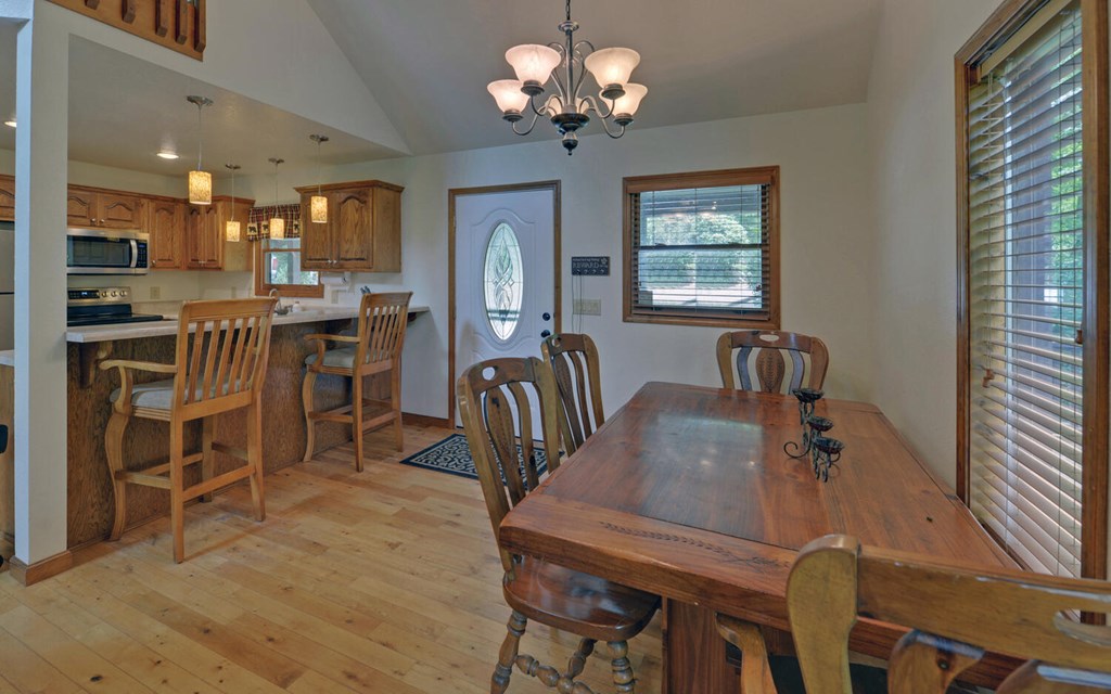 56 Waxwing Trail Murphy, NC 28906 - Photo 8 of 49 a view of a dining room with furniture a chandelier and wooden floor