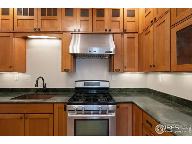 a kitchen with stainless steel appliances granite countertop a sink and cabinets