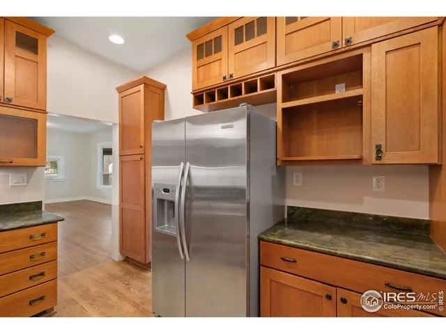a kitchen with stainless steel appliances granite countertop a refrigerator and a stove