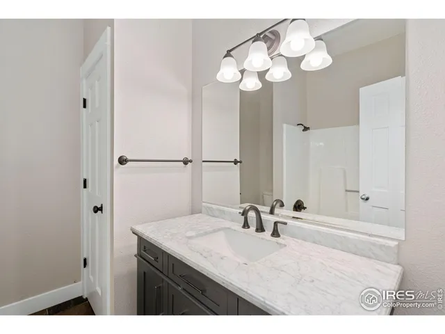 a bathroom with a sink vanity and a mirror