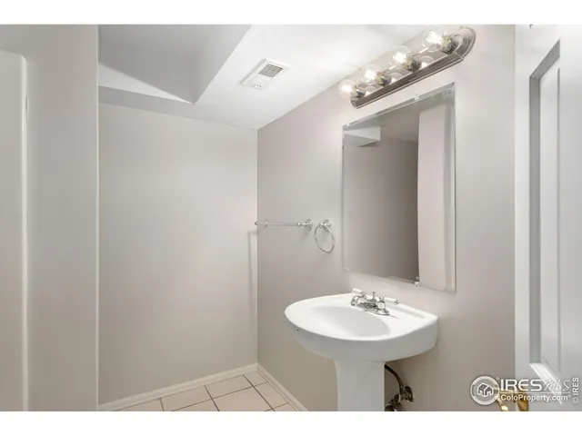 a bathroom with a sink a mirror and a toilet