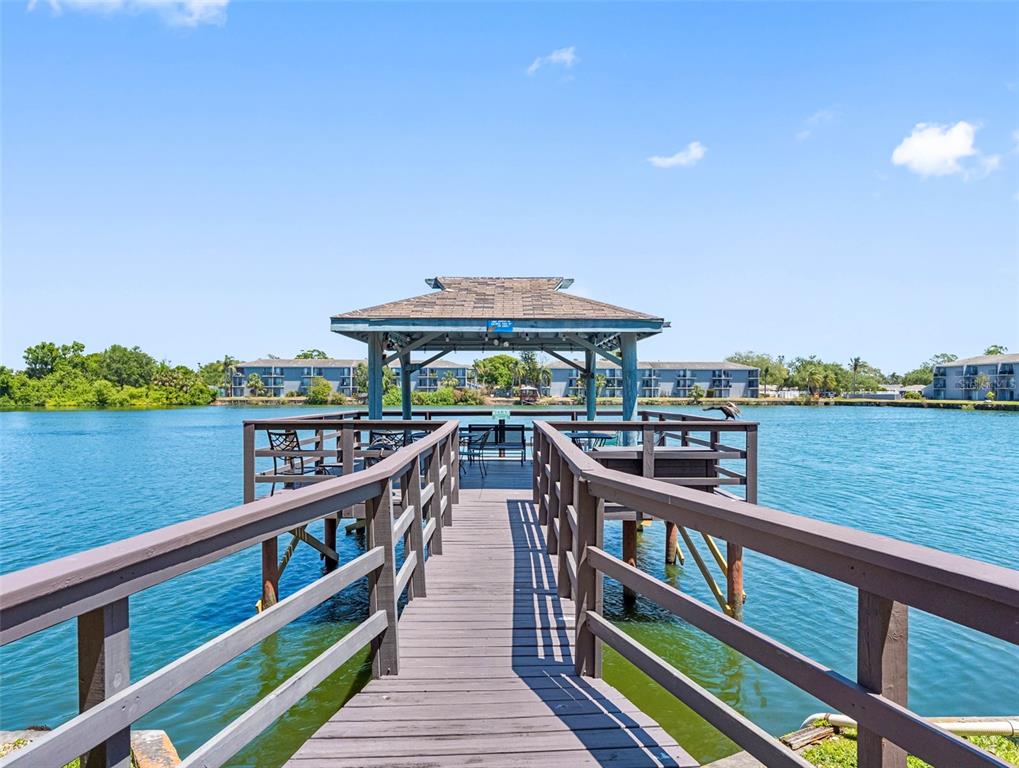 11485 Oakhurst Road, Unit 312 Largo, FL 33774 - Photo 1 of 1 a view of a balcony with wooden floor and fence next to a yard
