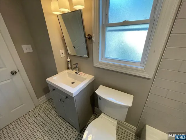 a white toilet sitting next to a bathroom sink