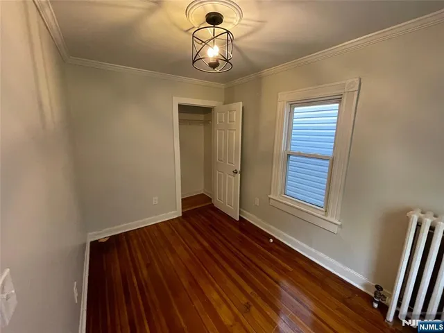a view of a livingroom with wooden floor and window