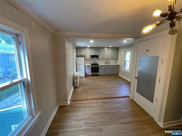 a view of kitchen with refrigerator microwave and stove