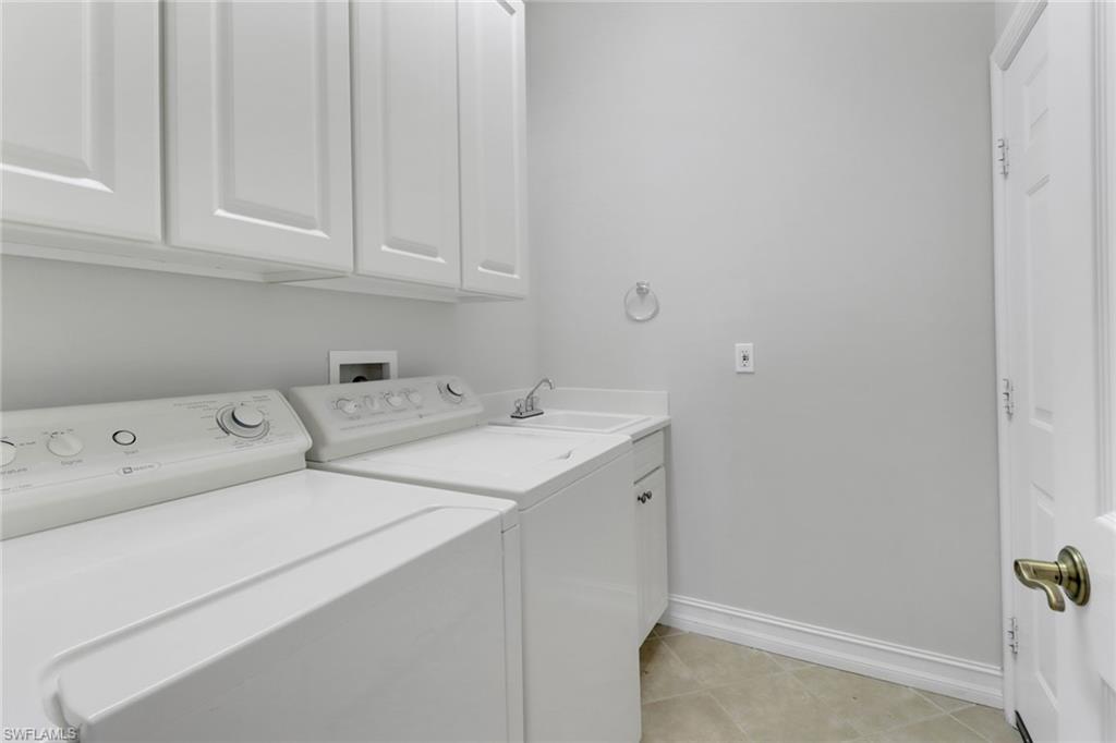 6757 Bent Grass Drive Naples, FL 34113 - Photo 21 of 27 a utility room with dryer and washer