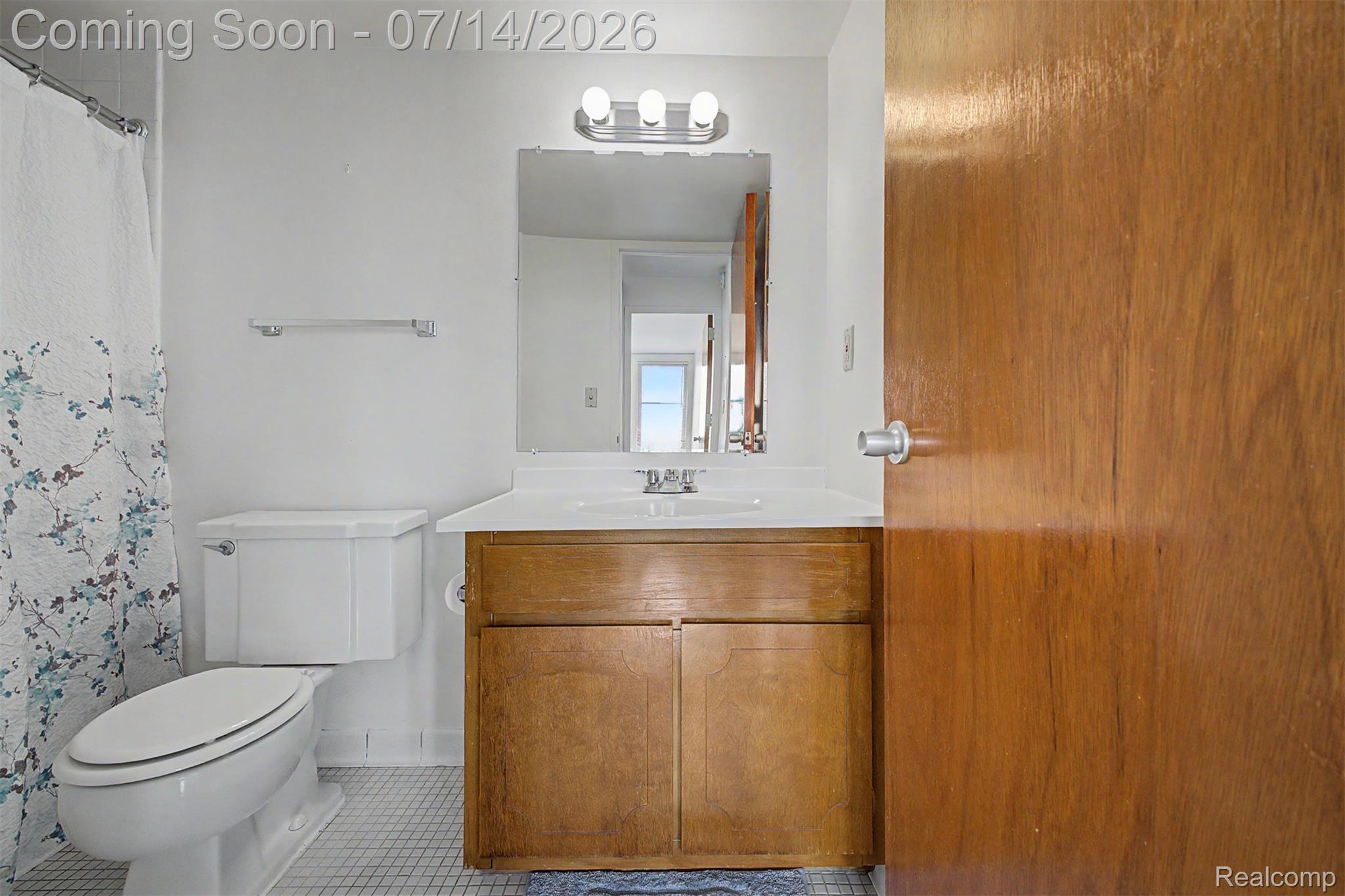 22700 Garrison Street, Unit 707 Dearborn, MI 48124 - Photo 16 of 22 Bathroom featuring a wood-finish vanity with an integrated sink and white countertop
