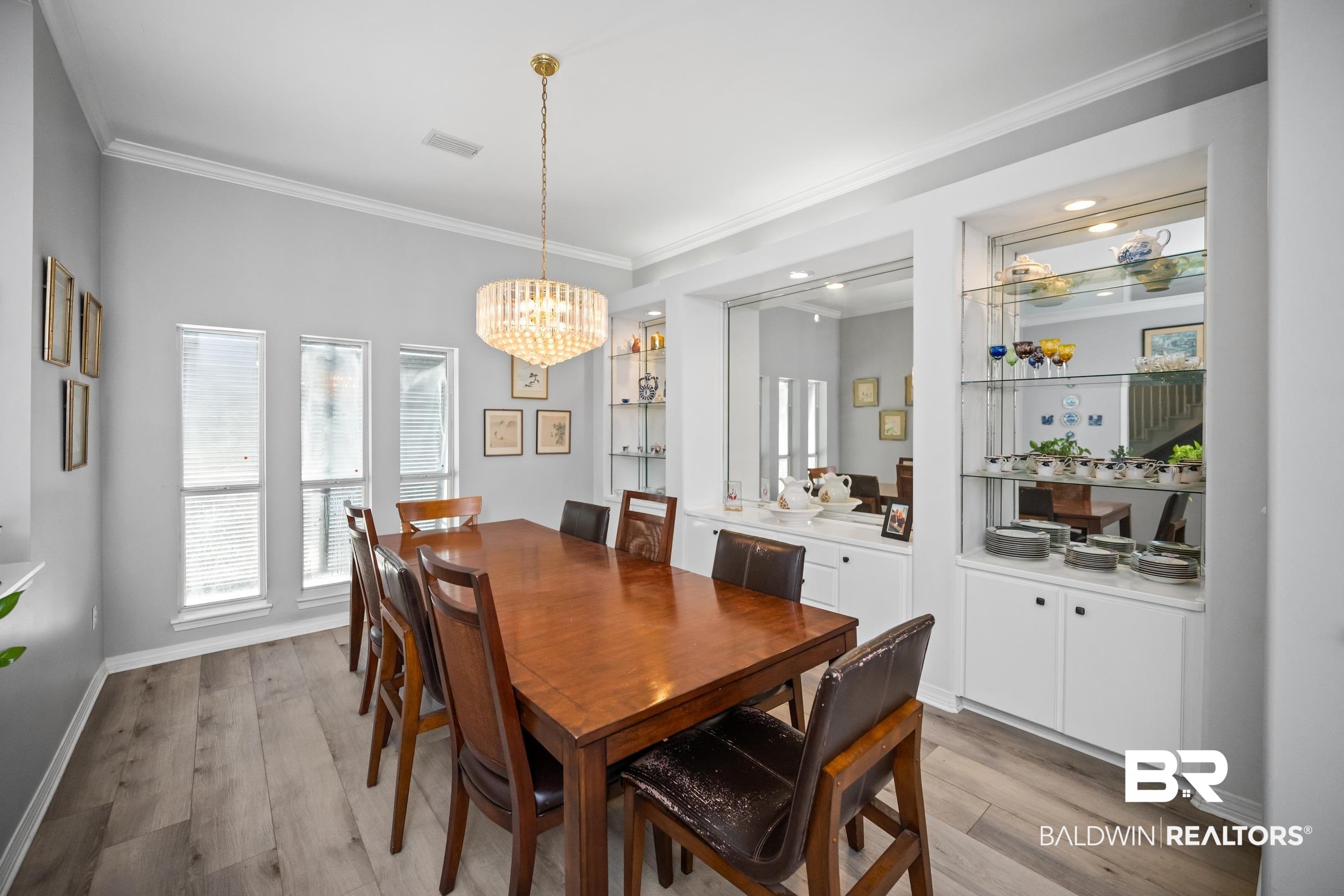 8585 Bay Harbor Road Elberta, AL 36530 - Photo 15 of 51 Dining space featuring a chandelier, ornamental molding, light wood-style flooring, and recessed lighting