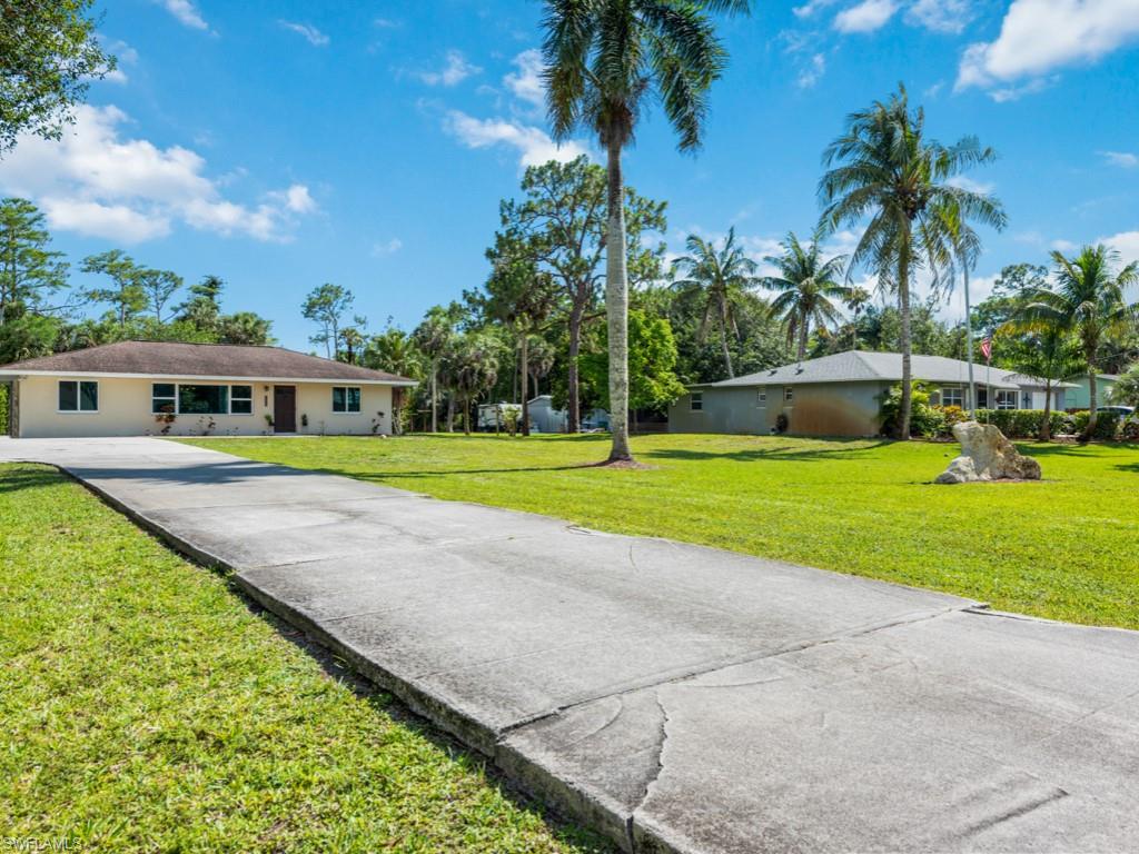 5300 Cypress Lane Naples, FL 34113 - Photo 1 of 14 a view of a house with a swimming pool