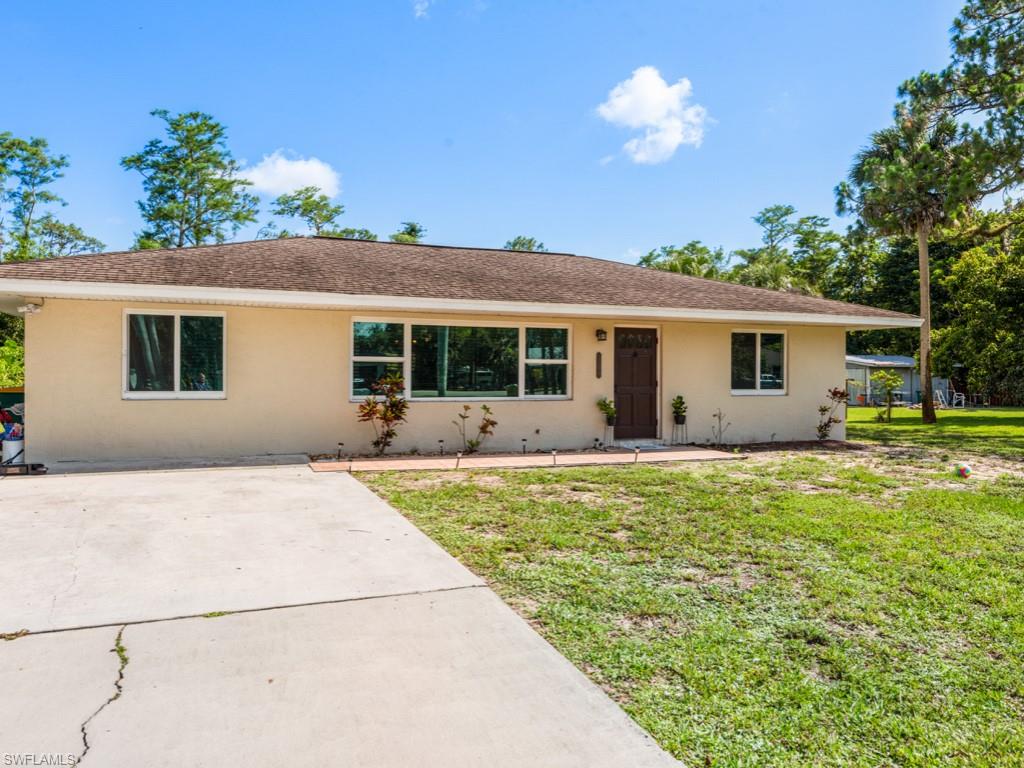 5300 Cypress Lane Naples, FL 34113 - Photo 2 of 14 a house view with a garden space