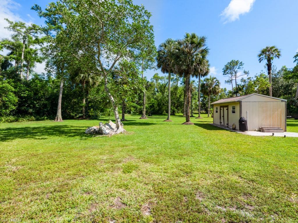 5300 Cypress Lane Naples, FL 34113 - Photo 3 of 14 a view of a house with backyard and trees