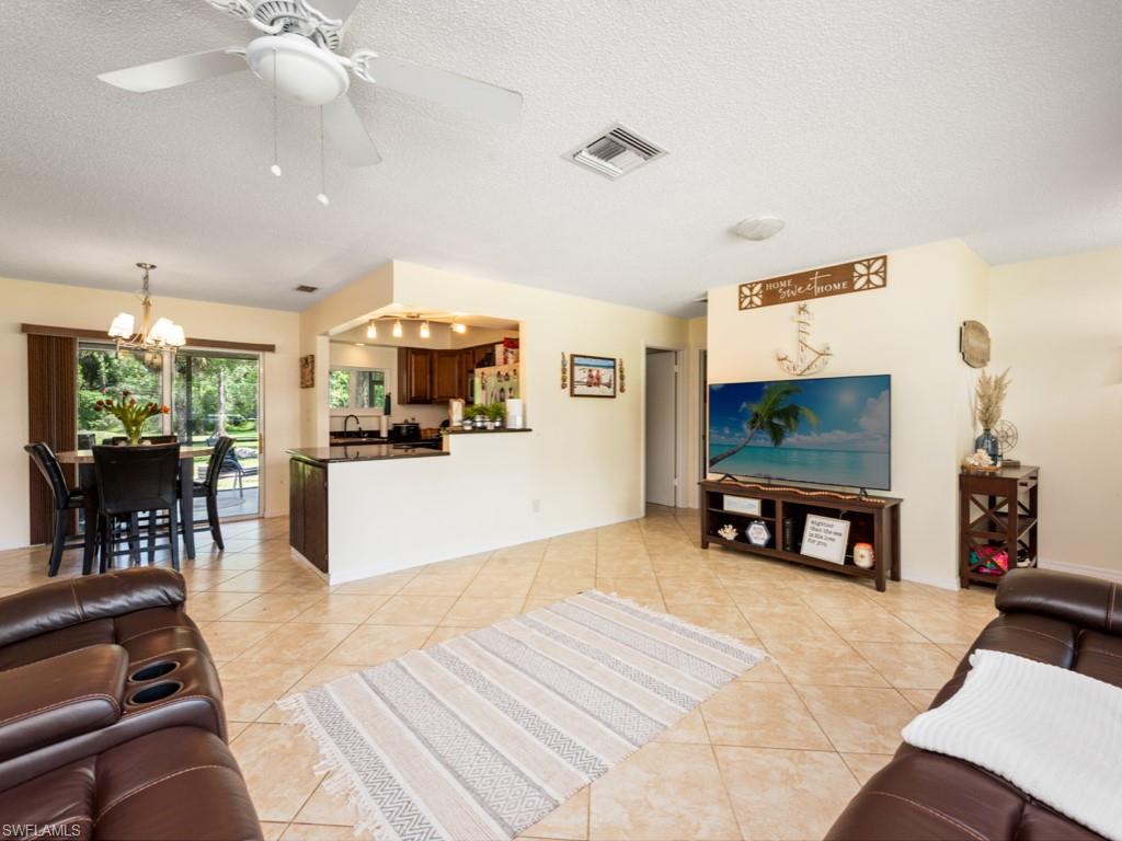 5300 Cypress Lane Naples, FL 34113 - Photo 6 of 14 a living room with furniture and a flat screen tv