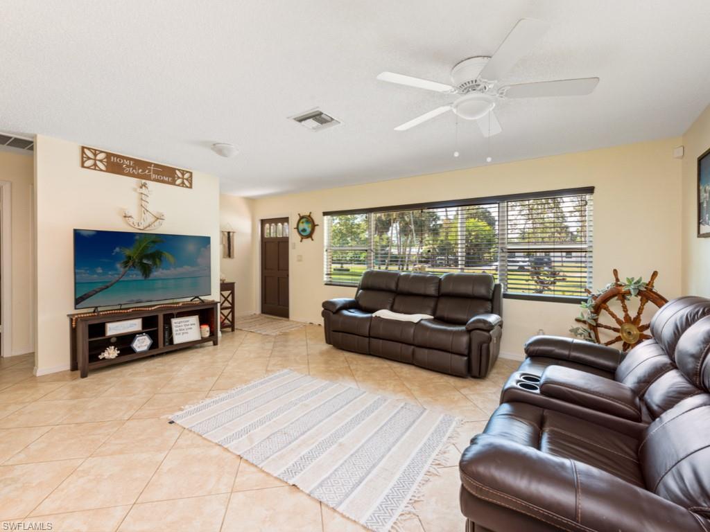 5300 Cypress Lane Naples, FL 34113 - Photo 7 of 14 a living room with furniture and a flat screen tv